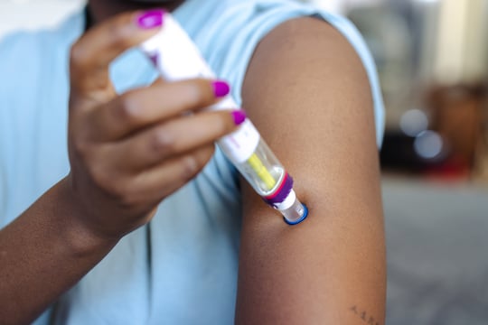 Woman Using Autoinjector